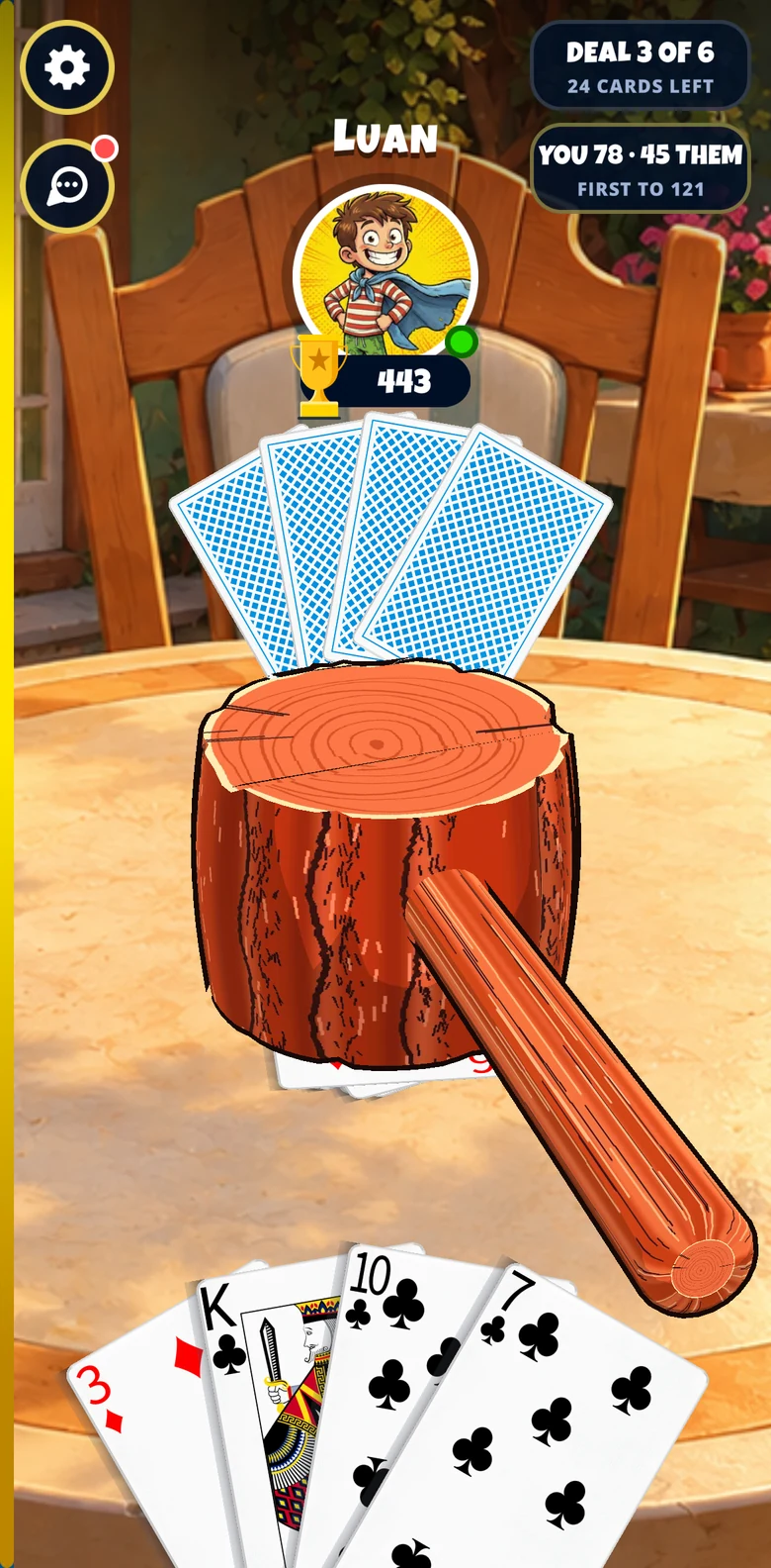 A match in progress: a giant wooden hammer, modelled in 3D, coming down on the pile in the middle of the table, with the opponent's photo and the score at the top.
